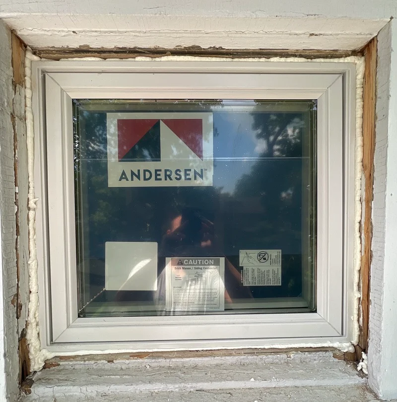 OSI spray foam sealing this Andersen window